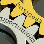 Dos engranajes perfectamente encajados, uno de color dorado con la palabra «business» escrita en él y el otro de color plateado con la palabra «opportunities» escrita en él, representando la oportunidad del dropshipping en Latinoamérica.